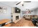 Cozy living room with brick fireplace, wood floors and comfortable leather seating at 9267 N State Road 135, Morgantown, IN 46160