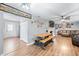 Open-concept living room with wood floors, brick fireplace, and comfortable leather furniture, creating a cozy atmosphere at 9267 N State Road 135, Morgantown, IN 46160