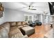 Bright living room featuring comfortable leather furniture and beautiful hardwood floors at 9267 N State Road 135, Morgantown, IN 46160