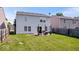 Backyard with green grass, small patio, and wooden privacy fence at 9497 W Stargazer Dr, Pendleton, IN 46064
