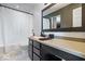 Well-lit bathroom features a sleek vanity with dark cabinets and a shower with a white curtain at 9497 W Stargazer Dr, Pendleton, IN 46064