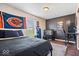 Comfortable bedroom with sports decor, dark accent wall, and desk area for studying or gaming at 9497 W Stargazer Dr, Pendleton, IN 46064