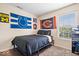 Bedroom featuring sports memorabilia, window with blinds, and dark wood laminate flooring at 9497 W Stargazer Dr, Pendleton, IN 46064