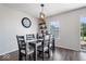 Charming dining area features a stylish light fixture, decorative shelving, and sliding glass door to the yard at 9497 W Stargazer Dr, Pendleton, IN 46064
