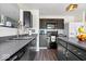 Modern kitchen with dark cabinets, stainless steel appliances, and gray countertops at 9497 W Stargazer Dr, Pendleton, IN 46064
