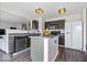 Modern kitchen boasts sleek black cabinets, stainless steel appliances, and a functional center island at 9497 W Stargazer Dr, Pendleton, IN 46064
