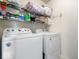 Laundry area features washer, dryer, and shelving for storage solutions at 9497 W Stargazer Dr, Pendleton, IN 46064