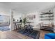 Open-concept living area with hardwood floors, a bar table, and a view into the living room at 9497 W Stargazer Dr, Pendleton, IN 46064