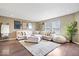 Spacious living room features dark floors, a plush sectional sofa, and lots of natural light at 9497 W Stargazer Dr, Pendleton, IN 46064