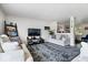 Open-concept living room with plush carpet, comfortable sofas, and a view into other rooms at 9497 W Stargazer Dr, Pendleton, IN 46064