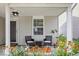 Inviting covered porch with seating area and flower boxes, perfect for relaxing outdoors at 9497 W Stargazer Dr, Pendleton, IN 46064