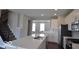 Modern kitchen boasts stainless appliances, sleek white cabinetry, and a center island at 954 Yorkshire Ln, Zionsville, IN 46077