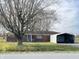 Charming single-story brick home featuring mature trees, a covered entry, and a detached carport at 9842 N State Road 9, Pendleton, IN 46064