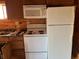 Functional kitchen with white appliances, wood cabinets, and a double sink at 9842 N State Road 9, Pendleton, IN 46064