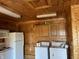 Kitchen area featuring a refrigerator, stove, microwave, and washer and dryer at 9842 N State Road 9, Pendleton, IN 46064