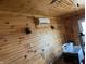 Wood-paneled room with ceiling fan and mounted air conditioner at 9842 N State Road 9, Pendleton, IN 46064