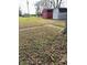 Three outbuildings stand on the lot with trees and fallen leaves in an otherwise clear yard at 9842 N State Road 9, Pendleton, IN 46064