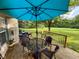 Outdoor deck with a table, chairs, umbrella and grill overlooking the lawn and trees at 9947 Comb Run Ct, Avon, IN 46123