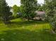 Aerial view of the backyard and the house in a tree lined setting at 9947 Comb Run Ct, Avon, IN 46123