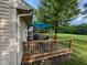 Backyard deck with outdoor dining area overlooking expansive lawn and mature trees at 9947 Comb Run Ct, Avon, IN 46123