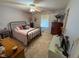 Spacious bedroom with soft carpet, a ceiling fan, and a decorative iron bed frame at 9947 Comb Run Ct, Avon, IN 46123