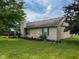 Exterior side view of a home featuring a backyard, deck, and landscaped garden at 9947 Comb Run Ct, Avon, IN 46123