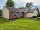 Well-maintained home with brick accents, a green lawn, and neat landscaping in a suburban setting at 9947 Comb Run Ct, Avon, IN 46123