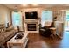 Bright living room features a fireplace, hardwood floors, and natural light from the sliding glass door at 9947 Comb Run Ct, Avon, IN 46123