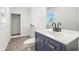 Bathroom featuring modern vanity, mirror, tiling, and shower in a brightly lit space at 1011 Robin Dr, Anderson, IN 46013
