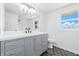 Elegant bathroom featuring a grey vanity with white countertop and black hexagonal tiled flooring at 1011 Robin Dr, Anderson, IN 46013