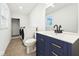 Bathroom featuring a tiled shower, washer and dryer, and updated vanity at 1011 Robin Dr, Anderson, IN 46013