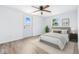 Bedroom features a door to the outside, ceiling fan and natural light at 1011 Robin Dr, Anderson, IN 46013