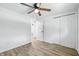 Bedroom with wood-look floors, ceiling fan, and closet with folding doors at 1011 Robin Dr, Anderson, IN 46013
