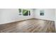 Bright bedroom with new laminate flooring and two windows providing natural light at 1011 Robin Dr, Anderson, IN 46013