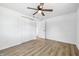 Bedroom with wood-look floors, ceiling fan, and double closet doors at 1011 Robin Dr, Anderson, IN 46013