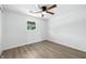 Bright bedroom with a ceiling fan and wood-look laminate flooring at 1011 Robin Dr, Anderson, IN 46013