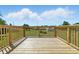 A spacious, wooden deck with wooden railings offers serene outdoor living with an expansive view at 1011 Robin Dr, Anderson, IN 46013