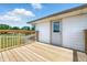 A wooden deck with a white door for easy access and wooden railings offers a private outdoor space at 1011 Robin Dr, Anderson, IN 46013