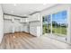 Bright, updated kitchen featuring white cabinets, tile backsplash, new sink and a sliding glass door at 1011 Robin Dr, Anderson, IN 46013
