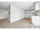Freshly painted, spacious kitchen area with new white cabinets and new flooring at 1011 Robin Dr, Anderson, IN 46013