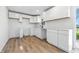 Updated kitchen featuring white cabinets, countertops, new flooring, and new fixtures, freshly painted at 1011 Robin Dr, Anderson, IN 46013