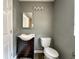Bathroom with a sink, mirror, toilet, and light fixture at 1016 W 31St St, Indianapolis, IN 46208