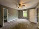 Spacious bedroom with ceiling fan, neutral paint, plush carpet, and natural light at 1016 W 31St St, Indianapolis, IN 46208