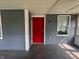 Charming front porch with a vibrant red door and grey siding at 1016 W 31St St, Indianapolis, IN 46208