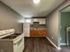 Galley kitchen featuring white appliances and white cabinets at 1016 W 31St St, Indianapolis, IN 46208