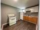 Galley kitchen featuring white appliances and white cabinets at 1016 W 31St St, Indianapolis, IN 46208