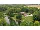 Aerial view of a brick home on a large lot with a pond and mature trees at 10198 N State Road 75, North Salem, IN 46165