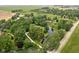 Aerial view of a property with ponds surrounded by lush trees and landscaping at 10198 N State Road 75, North Salem, IN 46165