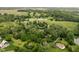 Aerial view showcasing the property's large lot with a serene pond and mature trees at 10198 N State Road 75, North Salem, IN 46165