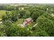 Aerial view of a charming brick home with a garage and pond surrounded by mature trees at 10198 N State Road 75, North Salem, IN 46165